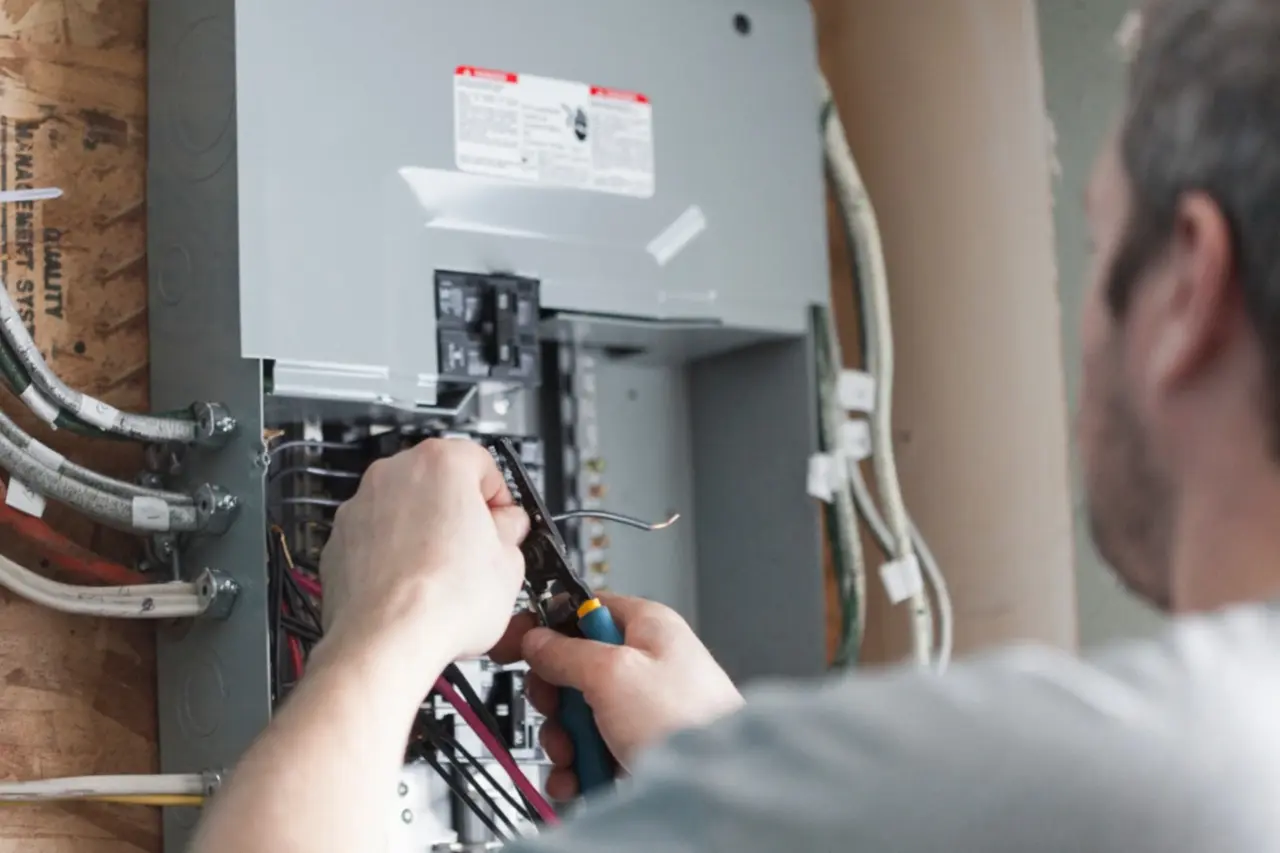 an electrician servicing a residential electrical panel