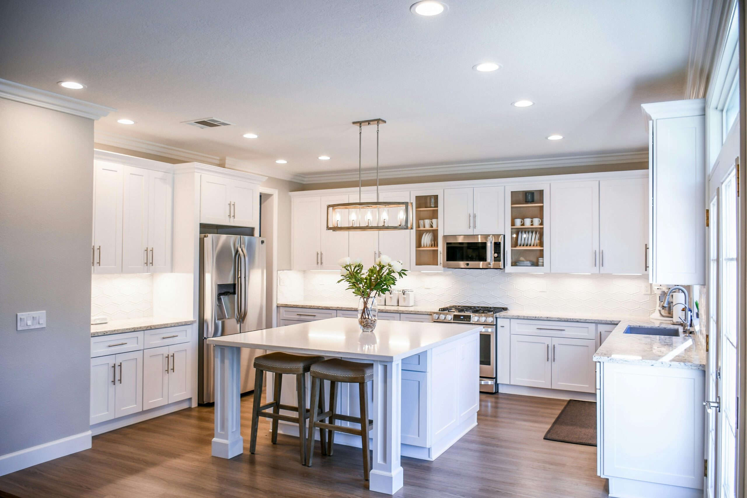a beautiful modern kitchen with can lights