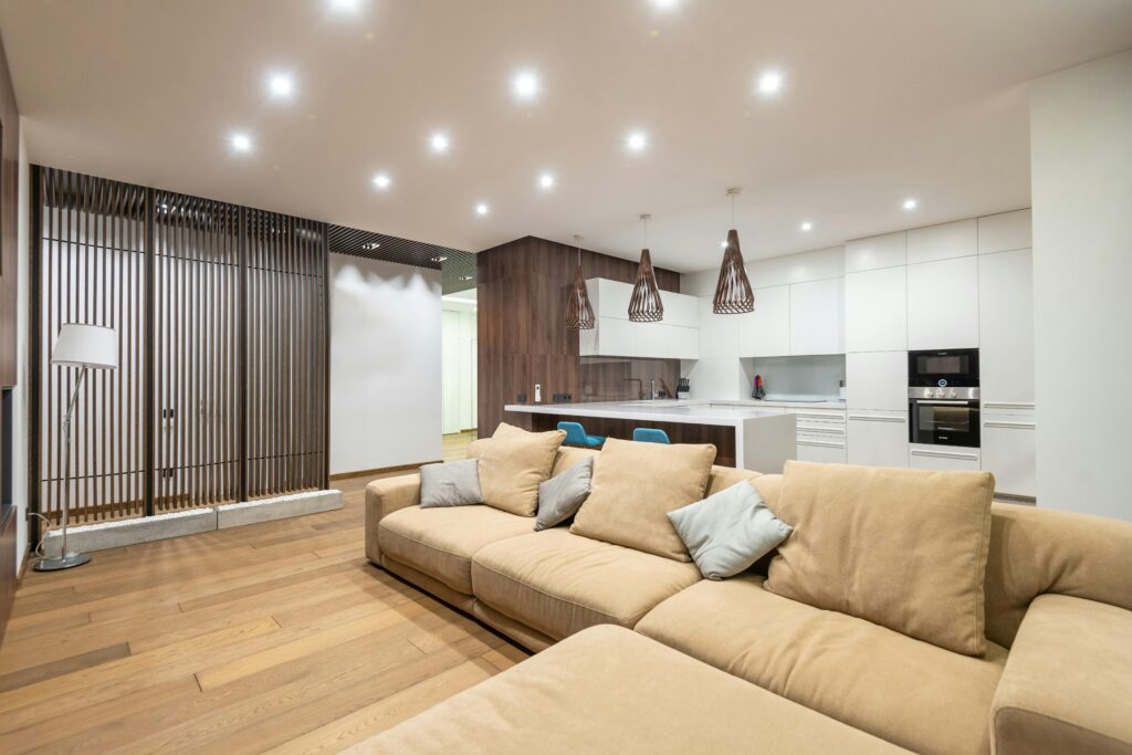 a modern living room and kitchen with many can lights